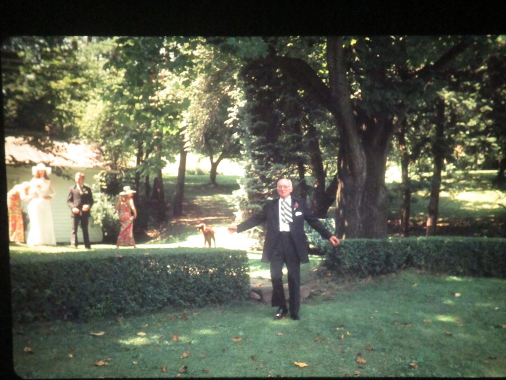 Mary Meyer's Father, William Hockenberry, August 11, 1973 walking through the privet hedge at her wedding reception at the family farm.