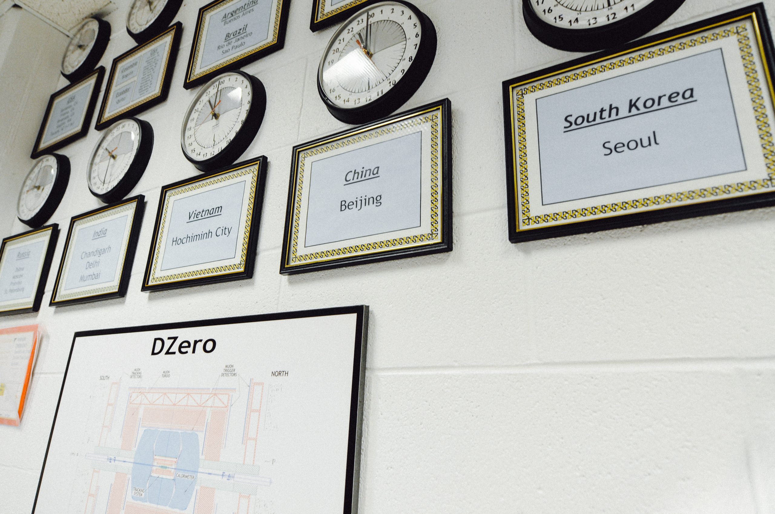 Clocks hanging on a wall set to various timezones