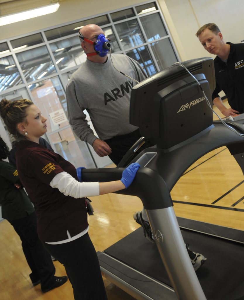 Man runs on a treadmill while taking the VO2 Max test to measure oxygen consumption.