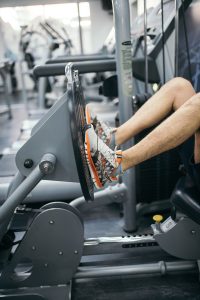 person using the leg press machine in a fitness center