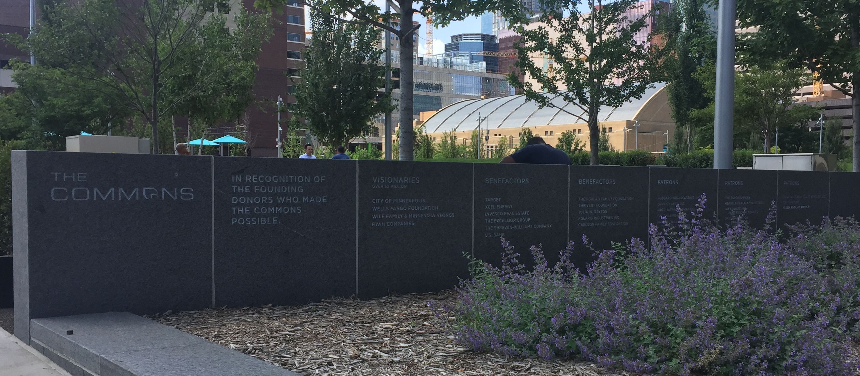 A wall with donor names inscribed on it.